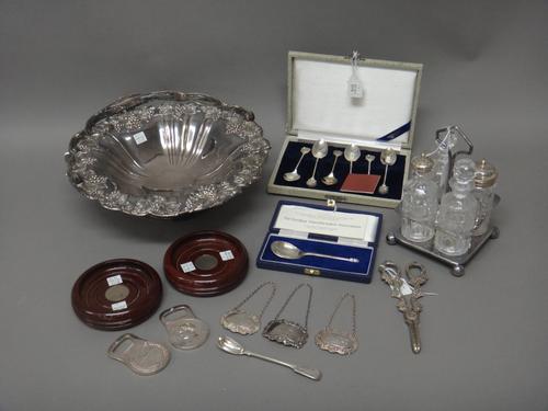 Silver, comprising; a spoon, having a fig shaped bowl and with a pine cone finial, with a case, three decanter labels, detailed Whisky, Brandy and Por