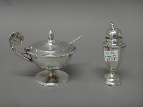 A silver hinge lidded mustard pot, of classical inspired design, with a cone finial to the lid, Sheffield 1919, with a blue glass liner, a salt spoon,