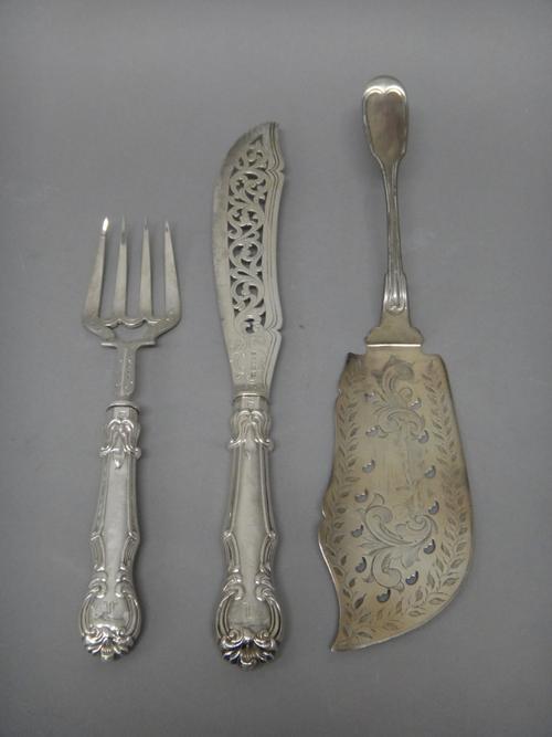 A Tiffany & Co fiddle and thread pattern fish slice, with pierced and engraved decoration and a pair of Victorian silver fish servers, with scroll pie