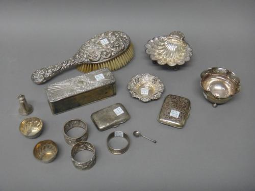 Silver and silver mounted wares, comprising; a shaped circuclar bowl raised on three spherical feet, Birmingham 1905, a butter shell raised on three s