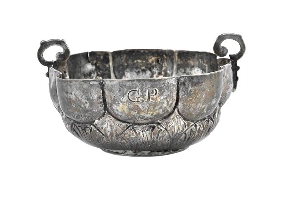 A twin handled shaped circular bowl, of lobed form, with embossed decoration, initial engraved G.P, apparently unmarked, probably 18th century, diamet