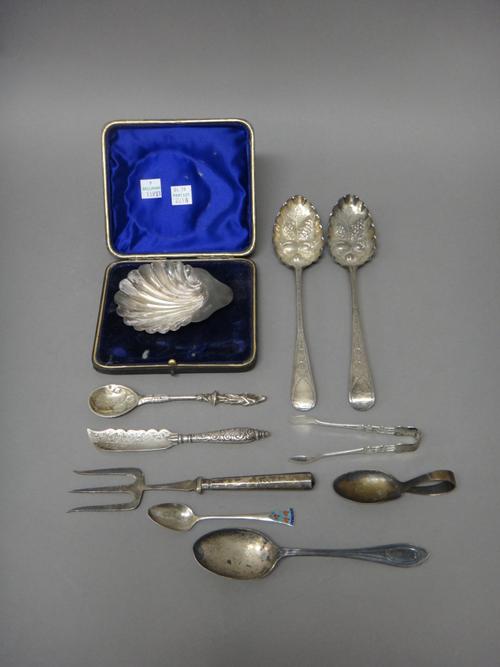 Mostly silver and silver mounted wares, comprising; two similar berry spoons, a butter shell, raised on three spherical feet, Birmingham 1899 with a c