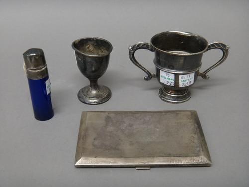 Silver and silver mounted wares, comprising; a rectangular cigarette case, with engine turned decoration, London 1937, a twin handled trophy cup, pres