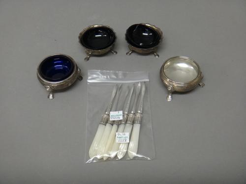 A set of six Victorian silver nut picks having mother-of-pearl handles, London 1892, two single circular salts each raised on three feet, including on