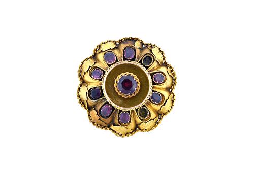 A Victorian gold and garnet set shaped oval brooch, mounted with the principal circular cut garnet to the centre, in a ropetwist surround and with a s