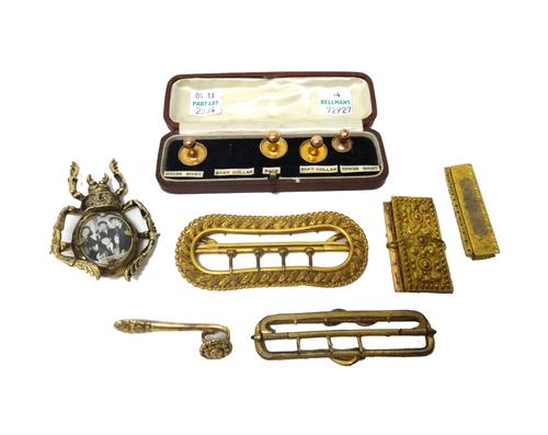 One gold dress stud, detailed 9 CT, three gilt metal dress studs, a studs' box, a gilt metal brooch, formed as a beetle, mounted with an oval panel, d