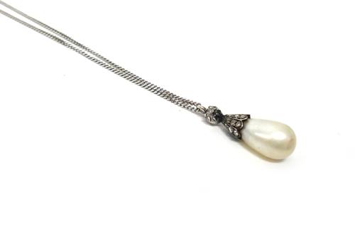 A diamond and cultured pearl drop shaped pendant, the single cultured pearl with a rose diamond set mount, with a cushion shaped diamond single stone