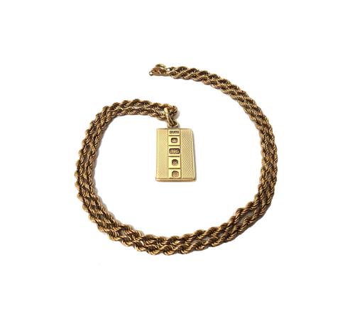 A 9ct gold rectangular pendant, formed as an ingot with engine turned decoration, with a 9ct gold ropetwist link neckchain, on a boltring clasp, combi