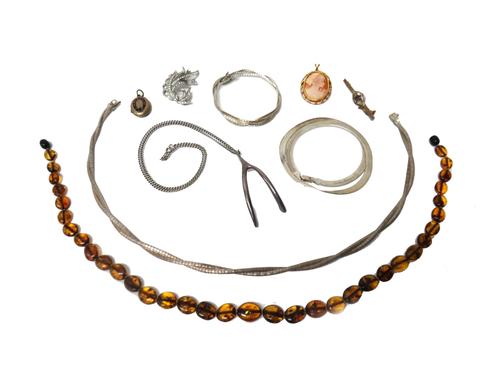 A oval shell cameo pendant brooch, two further brooches, a Victorian black enamelled pendant mourning locket, two pendants with neck chains, a multipl