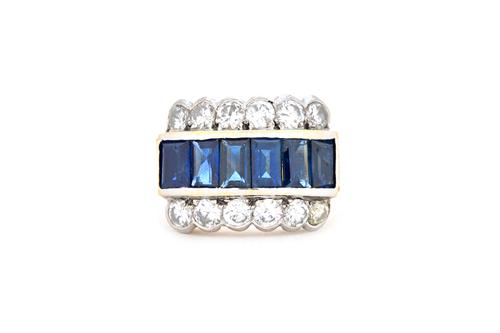 A sapphire and diamond ring, mounted to the centre with a row of six rectangular cut sapphires and with a row of six circular cut diamonds mounted to
