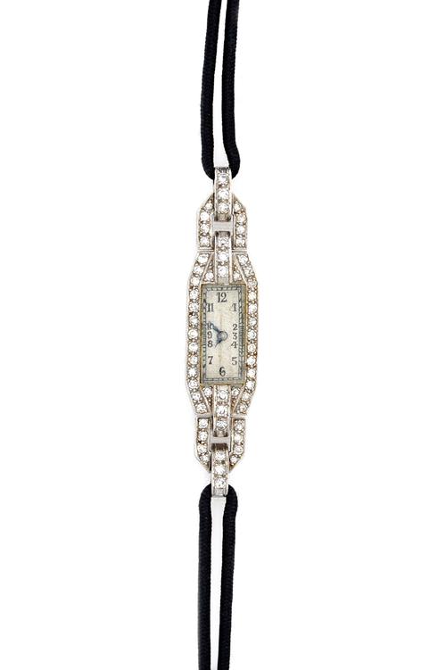 A lady's platinum cased and diamond set dress wristwatch, with an unsigned jeweled movement, detailed Swiss made, the rectangular silvered dial with b