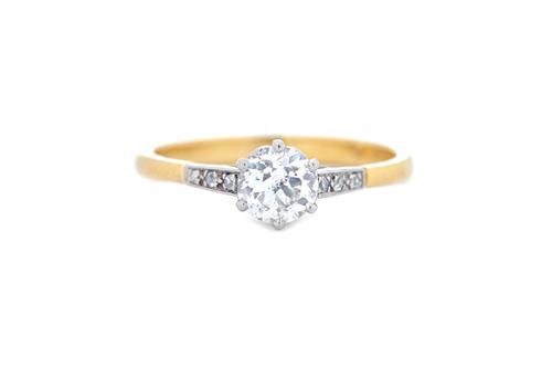 An 18ct gold and diamond ring, claw set with the principal circular cut diamond at the centre, between diamond set three stone shoulders, ring size Q.