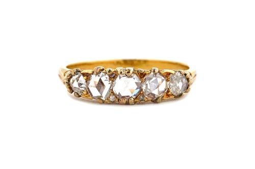 A gold and rose diamond set five stone ring, mounted with a row of rose cut diamonds, graduating in size to the centre stone, ring size N, with a case