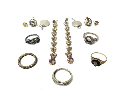 A 9ct gold and sapphire set cluster ring, a 9ct white gold and colourless gem set ring in a twist design, a gold and colourless gem set eternity ring,