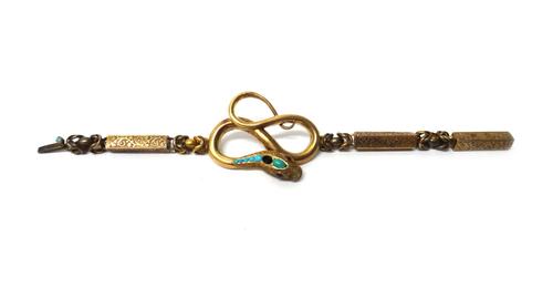 A Victorian gold and turquoise set bracelet, the front with a coiled serpent with a turquoise set head (one turquoise lacking) and with carbuncle garn