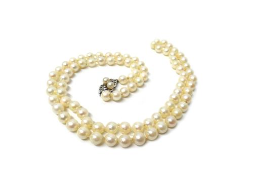 A single row necklace of uniform cultured pearls, on a Sterling, marcasite and imitation pearl clasp, length 72cm, with a case.