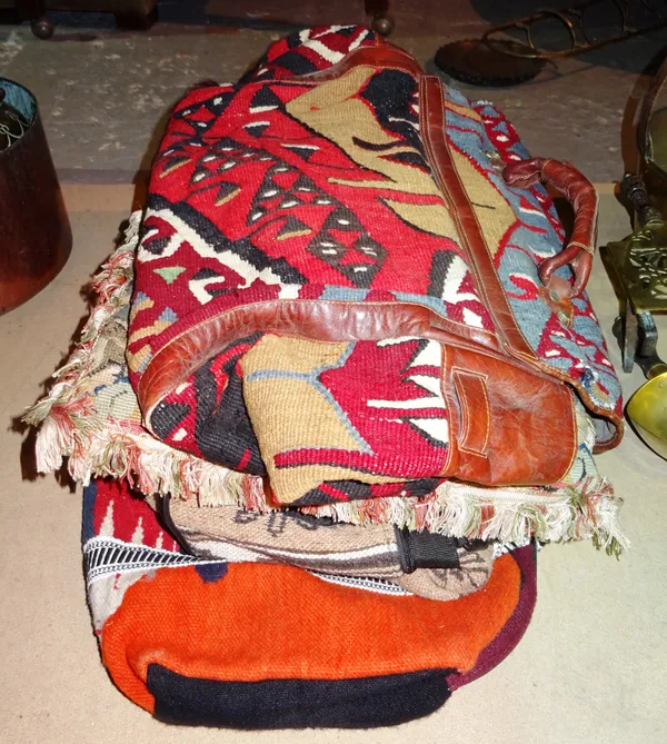 Textiles, comprising; a group of four holdalls in the South American style and a needlework cushion, (5).   S3B
