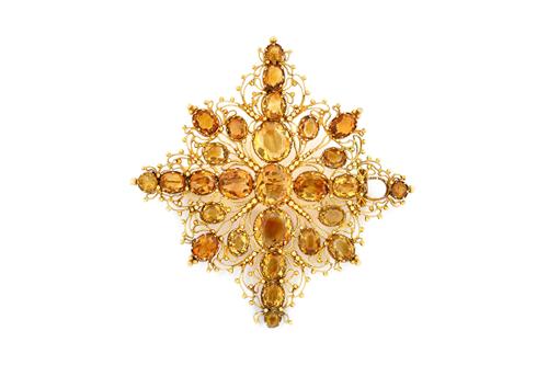 A filigree and citrine brooch, circa 1830, in a cruciform design, with beaded and wirework decoration, mounted with oval cut citrines, (one citrine la
