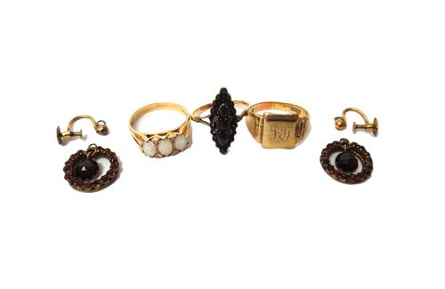 A gold, opal and diamond ring, mounted with three oval opals and with two pairs of circular cut diamonds, mounted at intervals, detailed 9CT, a 9ct go