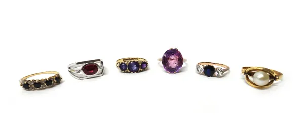A 9ct gold and amethyst set three stone ring, a gold ring mounted with a cultured pearl, an amethyst set single stone ring and three further gem set r