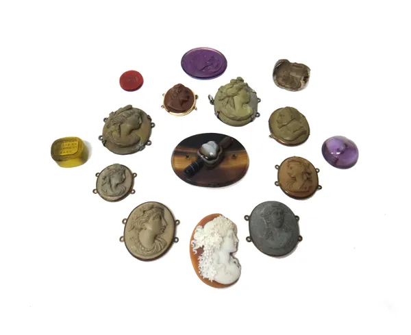 A group of six hardstones and pastes, including; a smoky quartz triple sided seal and two paste intaglios, eight lava cameos, each carved as a classic