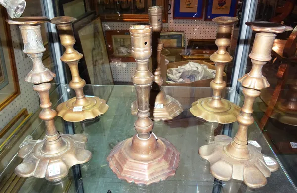 A group of 18th century and later bronze and brass candlesticks with petal bases, tallest 21cm (6). CAB