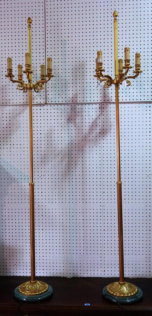 A pair of Victorian style three branch triform standard lamps, modern, on lions paw feet, 188cm high, and one further pair of five branch standard lam