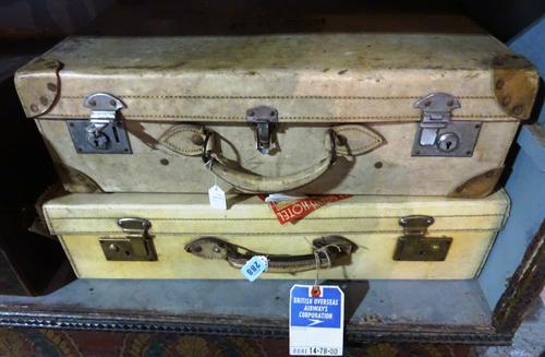 An early 20th century pig skin suitcase with vintage travel labels and a similar case, larger, 60cm x 38cm, (2).  H2