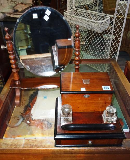 An early 20th century walnut desk tidy, with a pair of cupboards, 28cm wide, together with an oak swing frame mirror, 42cm wide, (2).  CAB
