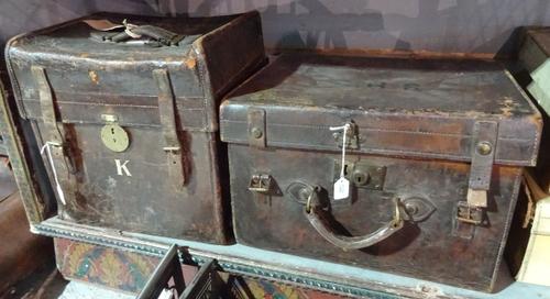 An early 20th century brown leather box case and another similar, the largest 46cm x 36cm, (2).  H2