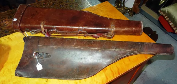 An early 20th century brown leather leg of mutton gun case and a brown leather gun slip, (2).  H2