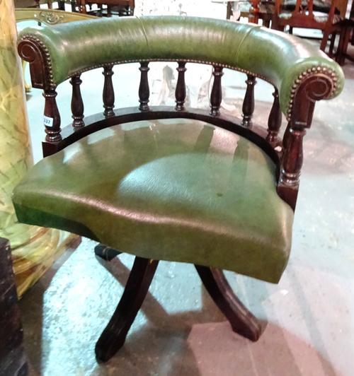 A green faux leather upholstered tub back swivel office chair, 70cm wide x 77cm high.  I7