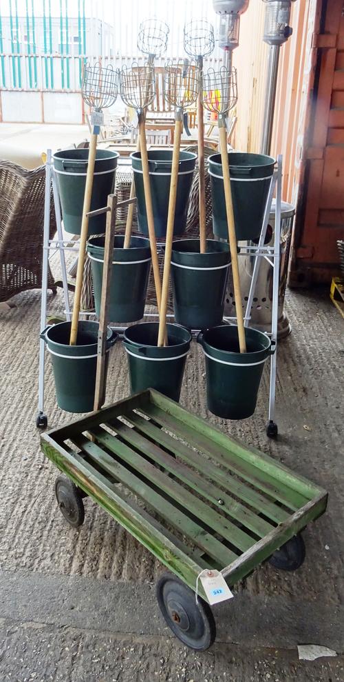 Garden statuary, including; a 20th century green painted four wheel trolley, a three tier flower display stand and a group of apple pickers, (qty).  O