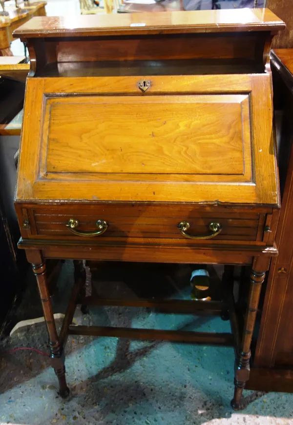 An early 20th century fruitwood student's bureau, on tall turned supports, 59cm wide x 108cm high.  G5