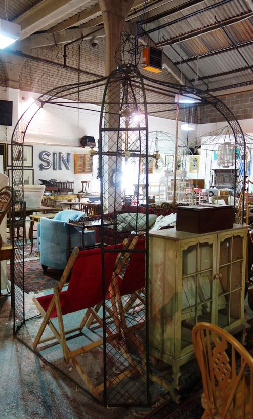 A 20th century green painted metal rose arbour, with dome top and crown style finial, 155cm wide x 250cm high. F4