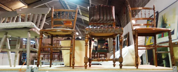A French leather upholstered mahogany chair and a pair of beech hall chairs with spindle back, (3).   F1