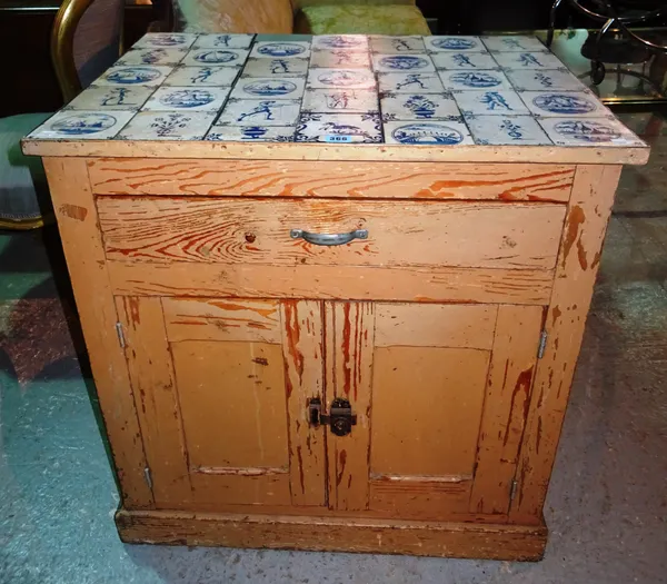 A 19th century North European painted pine side cabinet with faux Dutch Delft blue and white tiled top over single drawer and cupboards, 75cm wide x 7
