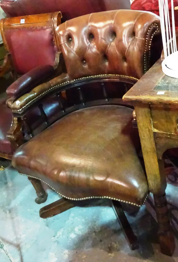 A 20th century brown leather upholstered mahogany framed swivel chair, 67cm wide x 90cm high.  E5