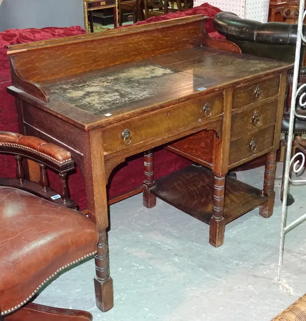 An early 20th century oak kneehole desk, with galleried top on ring turned block supports, 107cm wide x 92cm high.  E5