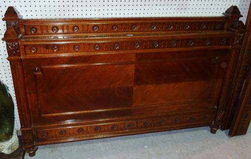 An early 20th century Continental beech framed single bed with carved decoration, 142cm wide x 94cm high.   G10