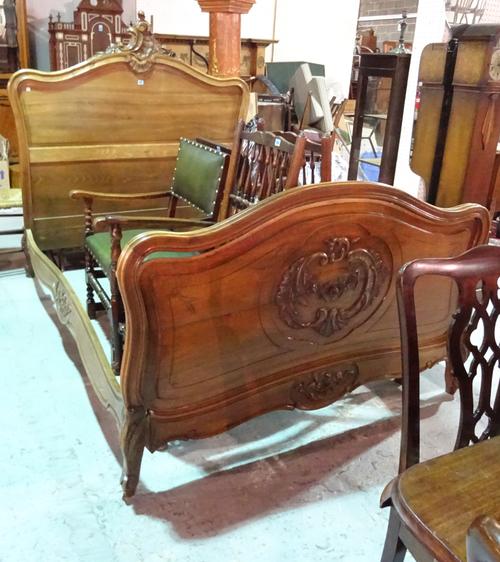 An early 20th century mahogany framed single bed with acanthus carved decoration, 142cm wide x 145cm high.   J6