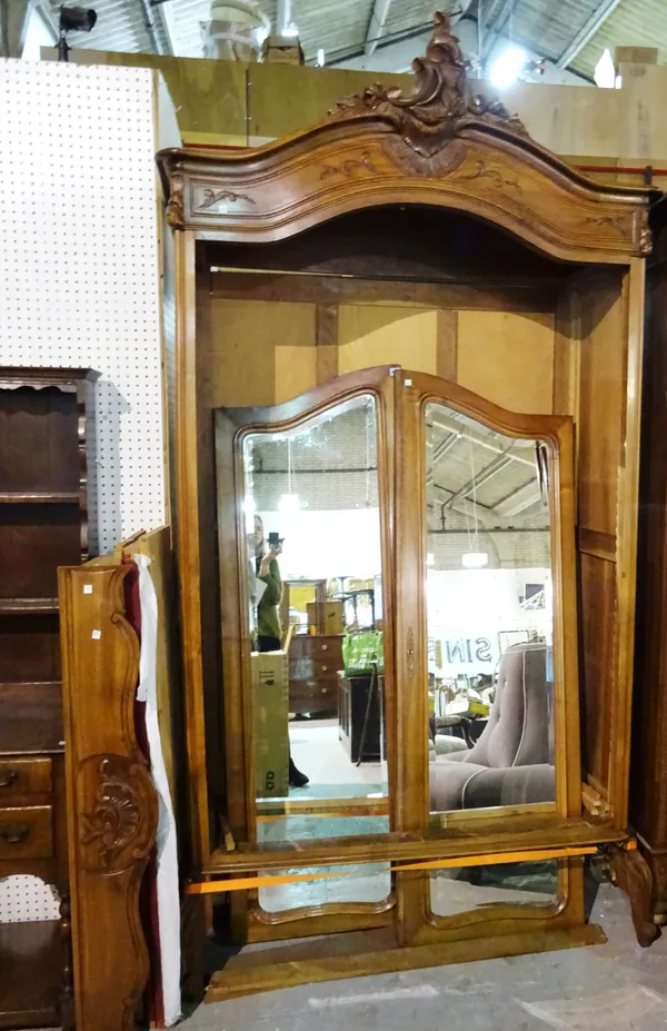 A 20th century Continental beech two door armoire with two arm top mirrored doors on turned square supports, 134cm wide x 200cm high.   M9