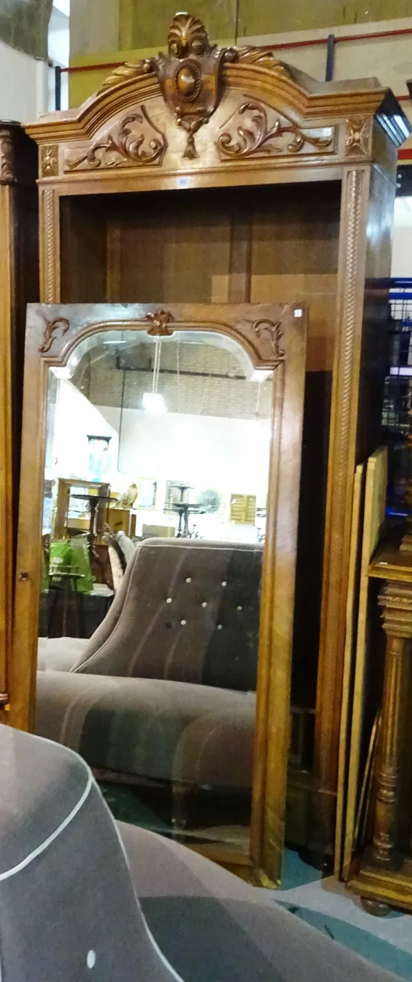 A 20th century Continental beech single armoire with mirrored door and carved acanthus crest, 98cm wide x 240cm high.   M9