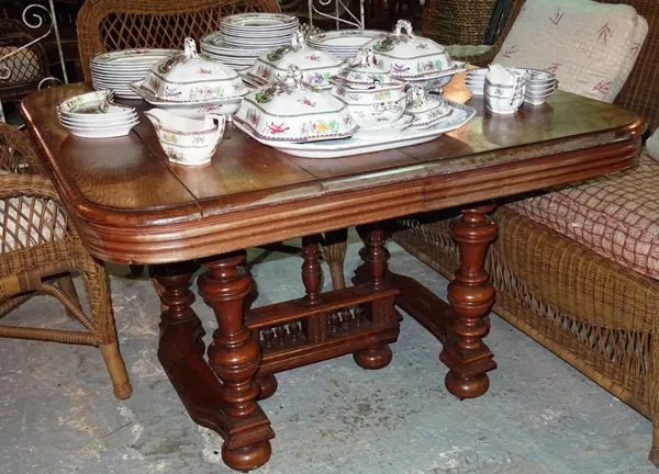 An early 20th century French oak extending dining table, on ring turned tapering supports, two extra leaves, 112cm wide x 80cm high x 210cm fully exte