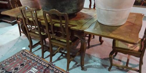 An early 20th century parquetry inlaid serpentine extending dining table on scroll supports, 136cm wide x 77cm high x 254cm fully extended.  C4