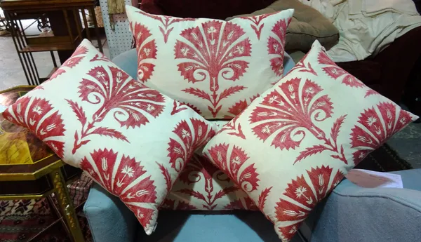 A group of four 20th century cream cushions with red patterned decoration, (4).  F4