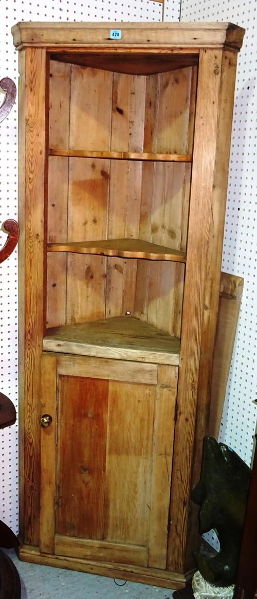 An early 20th century pine corner cupboard, 67cm wide x 182cm high.  G10