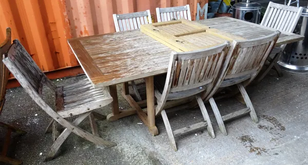 A 20th century hardwood rectangular extending garden table, together with a set of six folding garden chairs, (7).  OUT