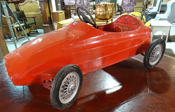An early 20th century red painted metal Maserati pedal car, 97cm wide.  H4