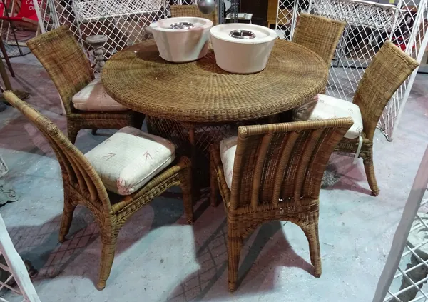 A 20th century rattan circular garden table, with octagonal base, 143cm wide x 78cm high, together with a set of six matching dining chairs, (7),   D2